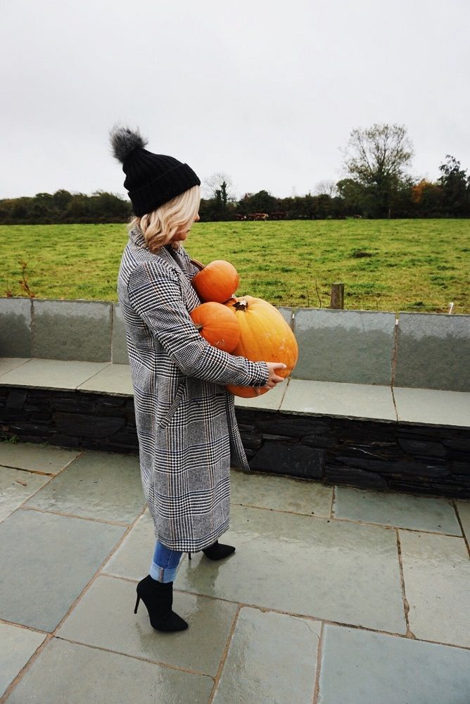 girl carrying pumpkins
